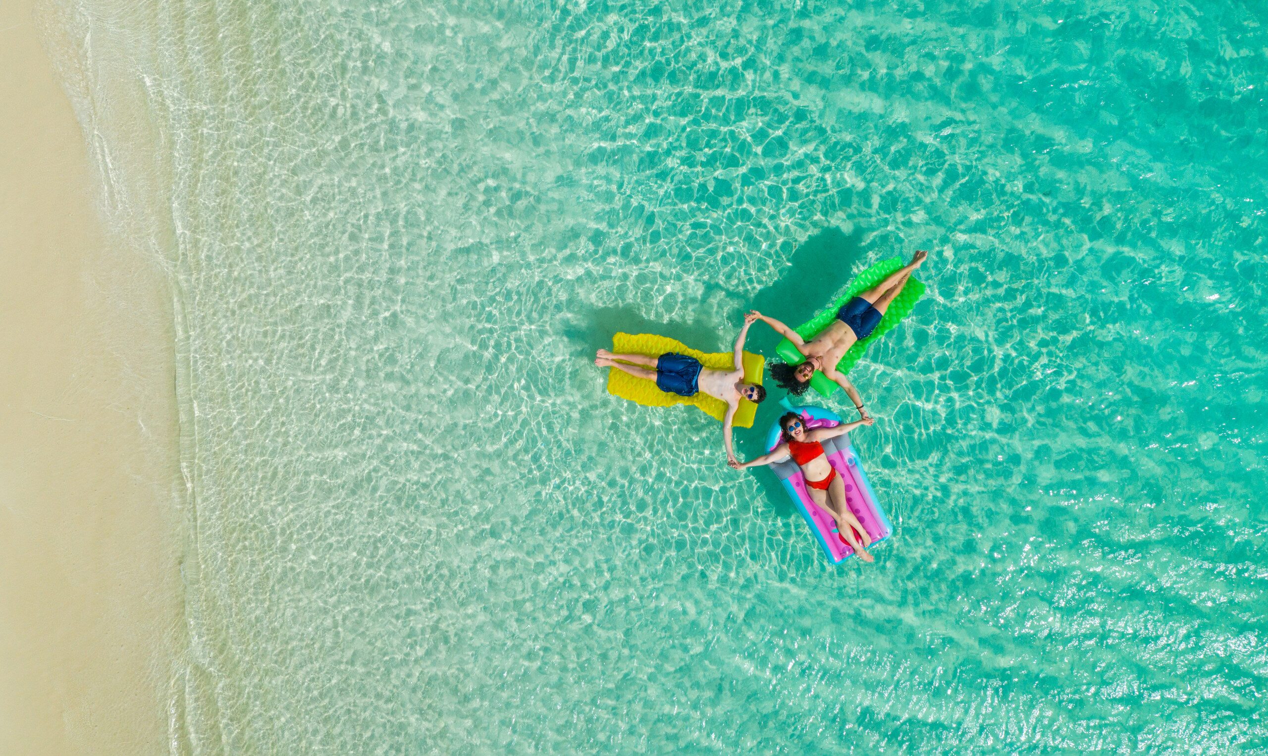 A family photographed from above on a Turks and Caicos beach