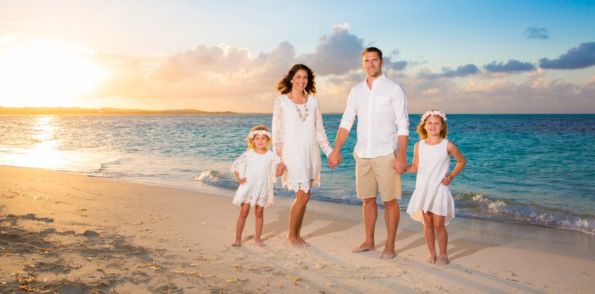 A couple photographed at golden hour on a Turks and Caicos beach