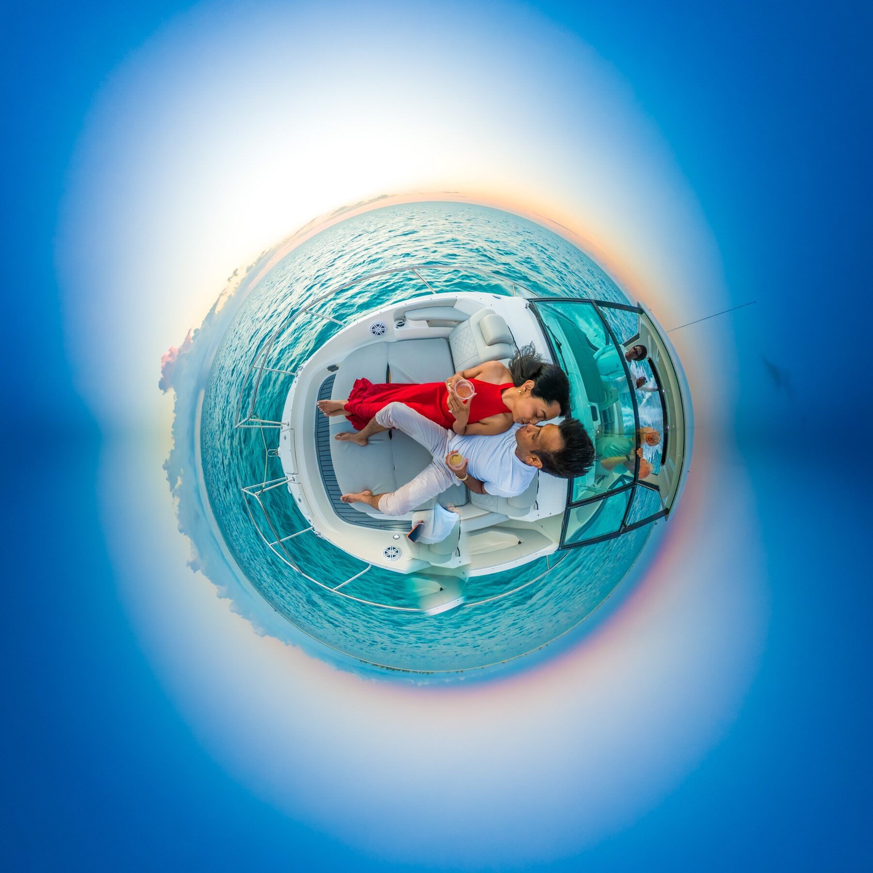 Little planet panorama of a couple relaxing on a boat off Turks and Caicos