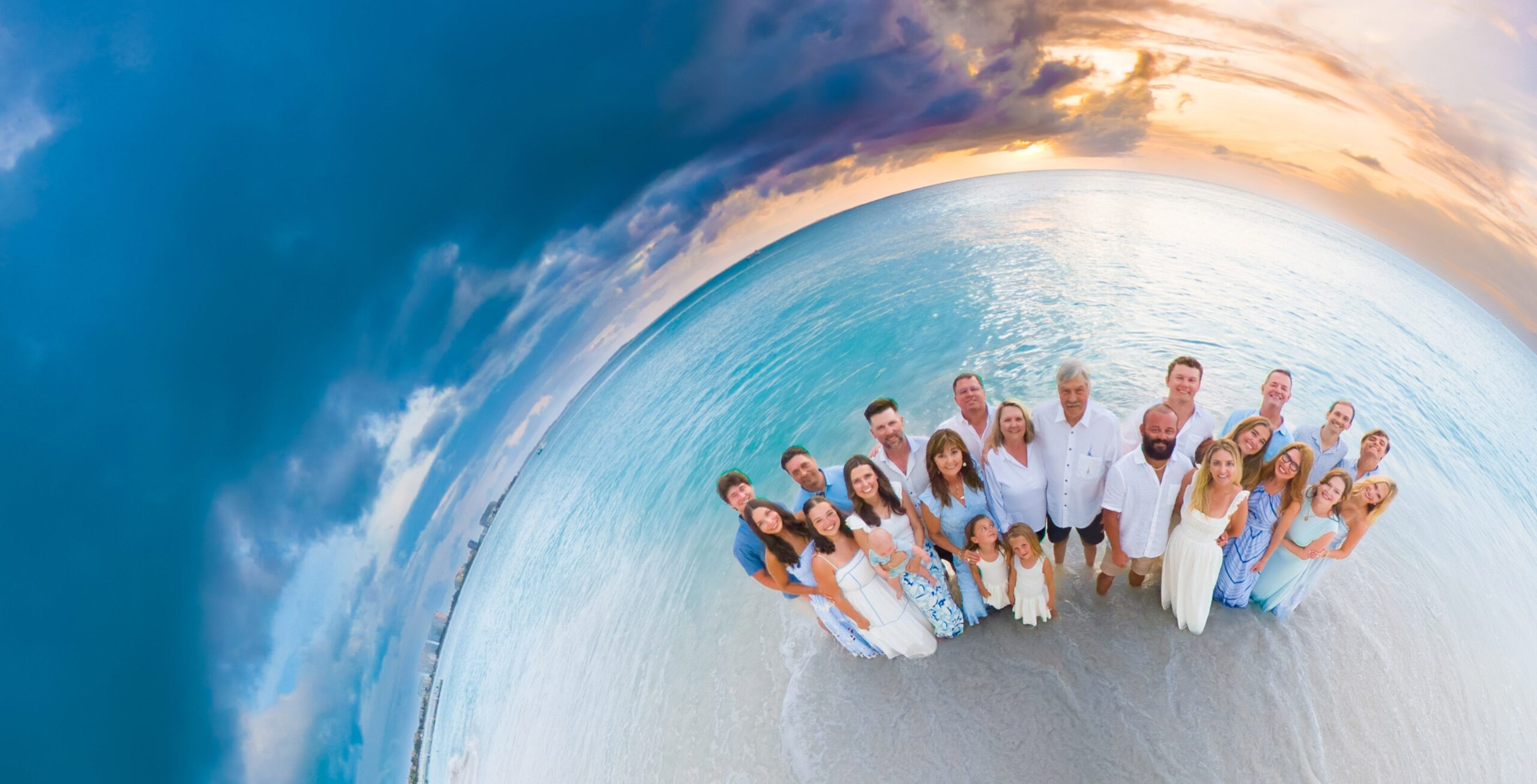 Wide-angle group portrait on a white sand beach
