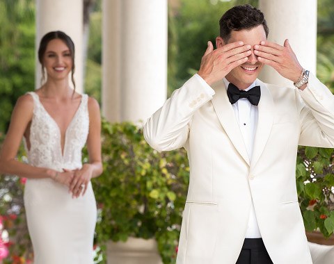 Groom covering his eyes before the first look