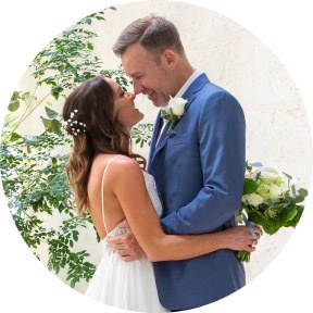 Bride and groom embracing in a tropical garden